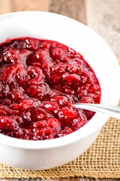 a white bowl filled with cranberry sauce on top of a table