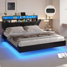 a bed with blue lights underneath it in a room that has white walls and flooring