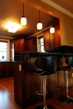 Cherry shaker cabinets, pendent lighting, flush mount in kitchen, looking from the dinning room in to kitchen featuring bar height leather stools. Lighting Flush Mount, In Kitchen, Flush Mount