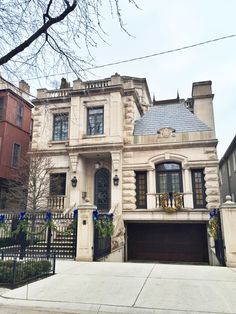 a large house with an iron gate in front of it