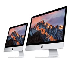 two computer monitors sitting side by side with mountains in the background