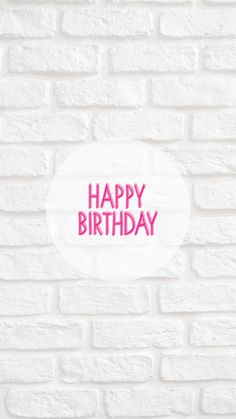 a white brick wall with the words happy birthday written in pink on it's side