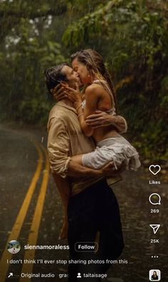 a man carrying a woman in the rain with an umbrella over his head while they are kissing