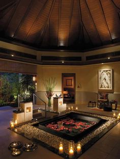 an indoor hot tub surrounded by candles