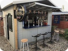 an outdoor bar with three stools and a sign that says miss's on it