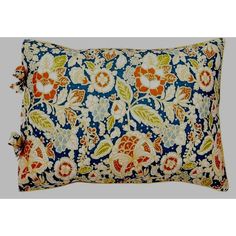 a blue and orange pillow with flowers on it