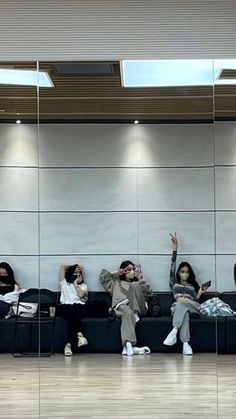 people sitting on couches in an airport waiting for their luggage