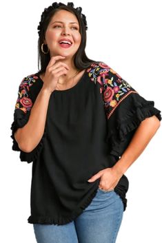 Step up your fashion game with our Floral Embroidered Round Neck Top! Crafted from a luxurious blend of 55% linen and 45% cotton, this top offers both comfort and style. The full front and back of this gorgeous top is a lovely solid go with anything black which provides a chic backdrop for the vibrant, multi-colored embroidery on the sleeves. The unfinished frayed hem adds a trendy, casual touch. Perfect for any occasion, this top is sure to become a staple in your wardrobe. Models are wearing s Spring Embroidered Rayon Blouse, Bohemian Rayon Tops With Floral Embroidery, Bohemian Rayon Top With Floral Embroidery, Spring Crew Neck Top With Embroidered Hem, Spring Floral Embroidered Rayon Blouse, Spring Cotton Embroidered Sleeve Top, Spring Rayon Blouse With Floral Embroidery, Floral Embroidered Short Sleeve Blouse For Fall, Floral Embroidered Short Sleeve Fall Blouse