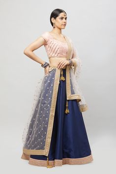 Customize your bridesmaids outfits today! This beautiful blush embroidered blouse contrasted with a navy blue A-line lehenga comes with a complementing blush dupatta! Fabric: Raw silk blouse and skirt, Net dupatta All custom orders will be handled by a Nazranaa Bridal Consultant who will virtually discuss measurements and minor changes according to the client's specifications Occasion: Wedding Ceremony Production time: 3.5-4.5 months Minimum order of 4 pieces WASH CARE INSTRUCTIONS - Please Dry Bridesmaid Bollywood Dupatta, Bridesmaid Choli With Zari Work, Traditional Bridesmaid Lehenga With Pallu, Anarkali Choli For Bridesmaid Festive Occasions, Festive Anarkali Choli For Bridesmaids, Traditional Dupatta For Bridesmaid Festive Occasions, Bollywood Style Bridesmaid Choli For Festive Occasions, Bollywood Style Lehenga Saree For Bridesmaid, Festive Anarkali Bridesmaid Choli