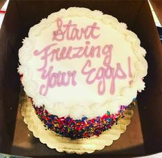 a birthday cake with frosting and sprinkles in a box that says start freezing your eggs