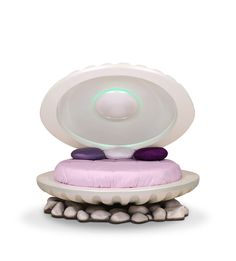 a white and purple object sitting on top of some rocks in front of a white background