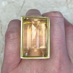 A stunning vintage citrine cocktail ring set in a beautiful Retro 18k yellow gold mounting. This mid-century ring is artfully sculpted with graduated concentric lines that lead to the citrine.
Circa 1940.
If you have any questions about this ring, please feel free to contact us. Modern Yellow Gold Topaz Ring With Rectangular Shape, Modern Gold Topaz Ring In Rectangular Shape, Modern Gold Rectangular Topaz Ring, Art Deco Gold Citrine Rings, Art Deco Citrine Gold Rings, Art Deco Gold Topaz Ring, Gold Art Deco Topaz Gemstone Ring, Art Deco Yellow Gold Topaz Ring, Art Deco Gold Topaz Gemstone Ring