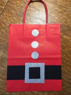 a santa clause bag sitting on top of a wooden table