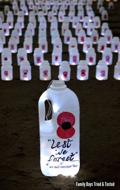 a large number of plastic bottles with the words best wishes written on them in red and white