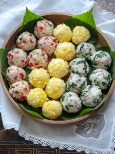 a wooden bowl filled with different types of food on top of a white table cloth