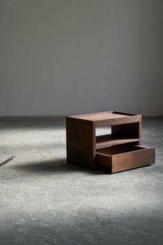 a wooden table sitting on top of a cement floor