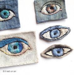 four pieces of fabric with different colored eyes on them