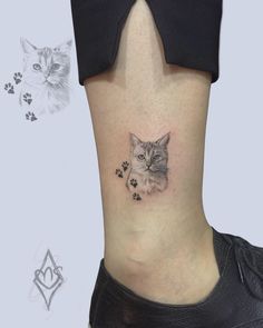 a cat and paw prints on the side of a woman's lower back leg