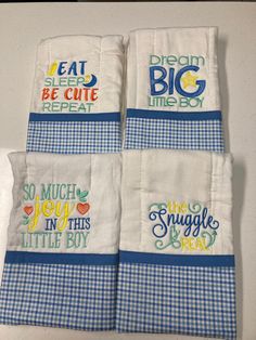 four kitchen towels with the words eat, sleep, be cute and repeat on them