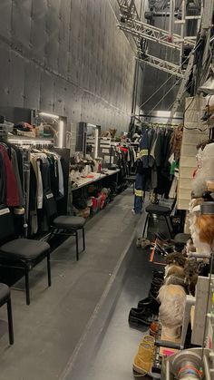 a room filled with lots of clothes and chairs