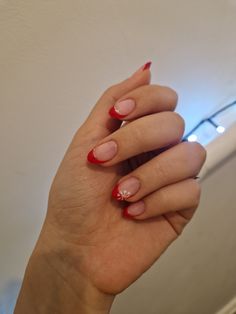 Candy Cane French Tip Nails Almond, Red French Tips With Candy Cane Ring Finger, Red Tip Nails With Pearls, Red French Tip With Silver Line, French Tip Nails Red And White, Red And White French Tip Nails Christmas, Red Tip Holiday Nails, Red French Tips With Snowflakes, Red French Tips Christmas