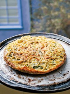 a pizza sitting on top of a pan covered in cheese