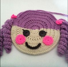 a crocheted bag with a smiling face on it