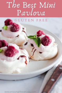 raspberry and chocolate pavlova on a white plate next to a fork