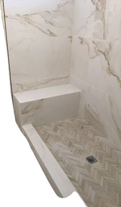 a bathroom with white marble walls and floor