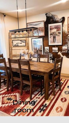 a dining room table with chairs and pictures on the wall