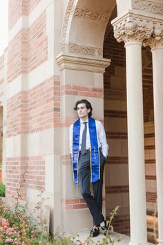 UCLA Graduate at royce arch leaning against the wall looking at powell library Pan Photography, Ucla Graduation, Graduation Pictures College, Individual Photoshoot, Photoshoot Graduation, Grad Picture Ideas