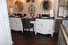 a bathroom with two sinks and mirrors on the wall