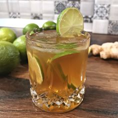 the dark and stormy cocktail is ready to be served in a glass with limes