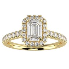 an emerald cut diamond ring set in yellow gold with diamonds around the band and shoulders