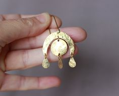 You will receive one pair of brass earrings from my brass jewelry collection. You can see the whole collection here: https://www.etsy.com/shop/ARTISUNtis?ref=seller-platform-mcnav&section_id=42470765 * Sun earrings/Rainbow earrings - there is a Rainbow over the Sun and a small Gold Rain drop :) * hammered earrings - hammered by hand for texture and unique pattern design * lightweight earrings - it is a pleasure to wear them * minimalist earrings - simple, but elegant design * everyday earrings and for special occasions * Perfect gift - suitable for gift to you or to the special one in your life * including "care instructions" * raw brass ear wire hook earrings  About material: Brass is a sturdy metal - combination of zinc and copper.  For that reason will naturally tarnish when exposed to Sun Earrings, Long Gold Earrings, Hammered Earrings, Hammered Brass, Earrings Simple, Rainbow Earrings, Women Christmas, Lightweight Earrings, Earrings Long