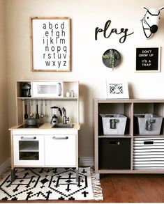 a playroom with shelves, bins and baskets on the floor