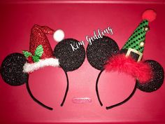 two mickey mouse ears with christmas hats on top of each other and the words kind of holiday written on them