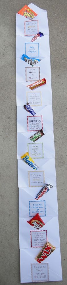 several candy bars lined up on top of each other in front of a white sheet of paper