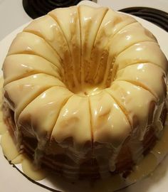 a bundt cake sitting on top of a white plate next to a stovetop