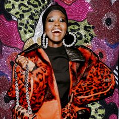 a woman in an animal print jacket and earrings