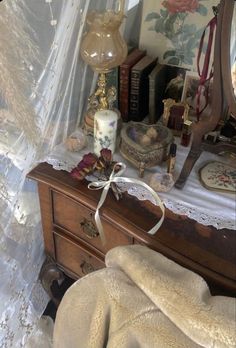 a bedroom with a dresser, mirror and other items on the table in front of it