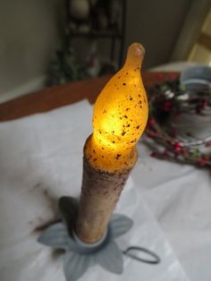 a lighted wine bottle sitting on top of a table