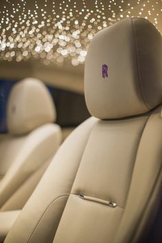 the interior of a car with sparkling lights on the ceiling and leather seats in it