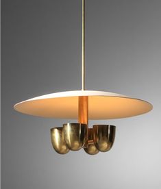 a light fixture with three lights hanging from it's sides and four bowls on the bottom