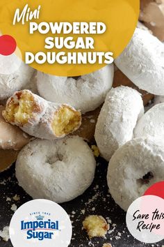 a pile of powdered sugar doughnuts sitting on top of a table