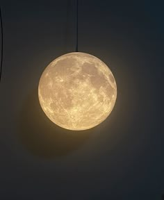 a full moon hanging in the dark sky