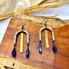 Unique statement earrings with hammered brass hanging from a patina'd wood piece & accented with blue Lapis dangles. Blue Bohemian Hammered Earrings, Bohemian Blue Hammered Earrings, Handmade Blue Brass Chandelier Earrings, Hammered Brass, Statement Earring, Glitter Glass, Blue Lapis, Leather Fringe, Gift Jewelry