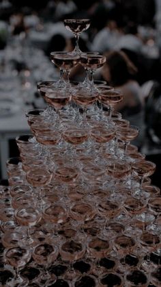 many wine glasses are stacked on top of each other