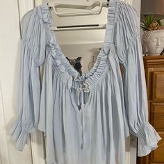 Pastel Blue Off The Shoulder Long Sleeve Blouse Light Blue Blouse For Fall Daywear, Light Blue Blouse For Spring Vacation, Light Blue Blouse For Vacation In Spring, Chic Light Blue Blouse For Daywear, Blue Flowy Blouse With Ruffles, Flowy Blue Blouse With Ruffles, Light Blue Long Sleeve Blouse For Day Out, Blue Ruffled Blouse For Daywear, Flowy Blue Peasant Top For Summer