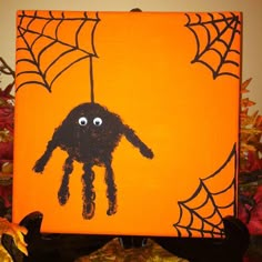 an orange halloween card with a spider on it